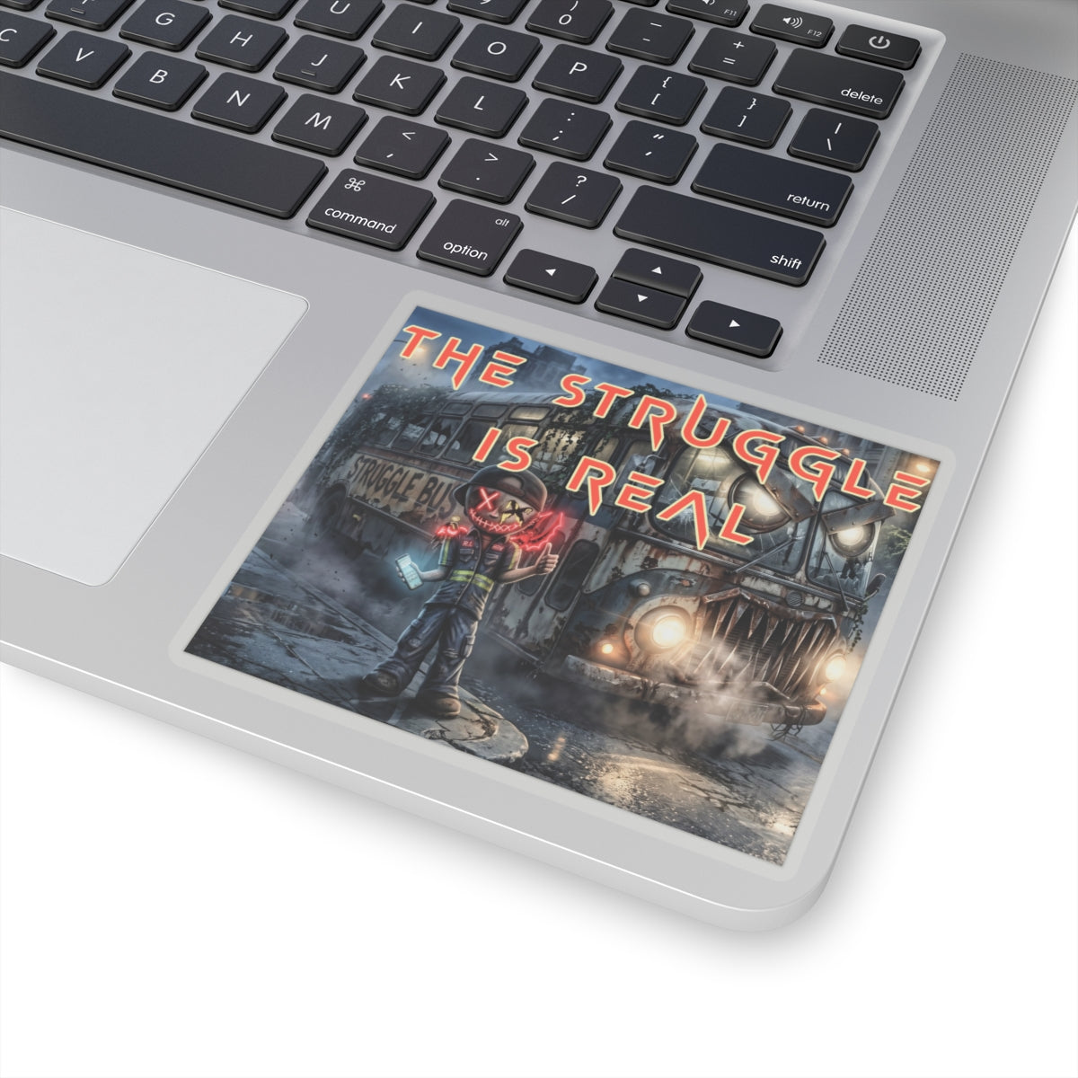 The Struggle Is Real kiss-cut sticker on a laptop — transparent finish, 4″ × 4″