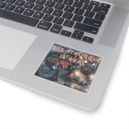 The Struggle Is Real kiss-cut sticker on a laptop — transparent finish, 3″ × 3″