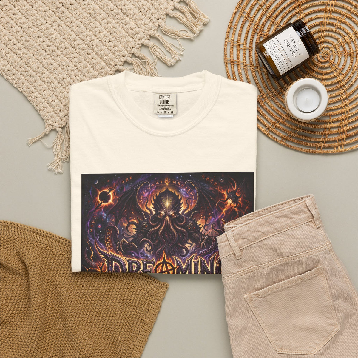 Dreaming of Chaos heavyweight tee — ivory, flat lay styled with props